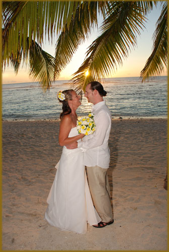 Wedding couple on the beach with the sun setting
